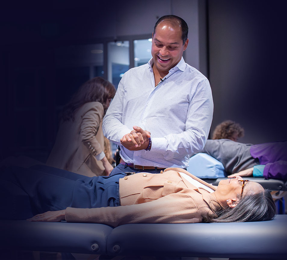 Dr. Garcia demonstrating advanced biomagnetism techniques with a seminar participant